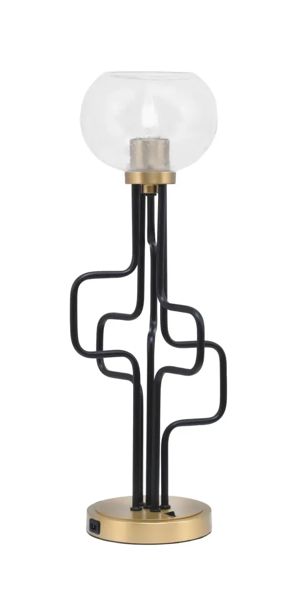 The Sandia Accent Lamp combines contemporary style with practical functionality. Featuring a striking matte black and aged brass finish with unique bubble glass shade, this compact lamp includes built-in USB ports for device charging.