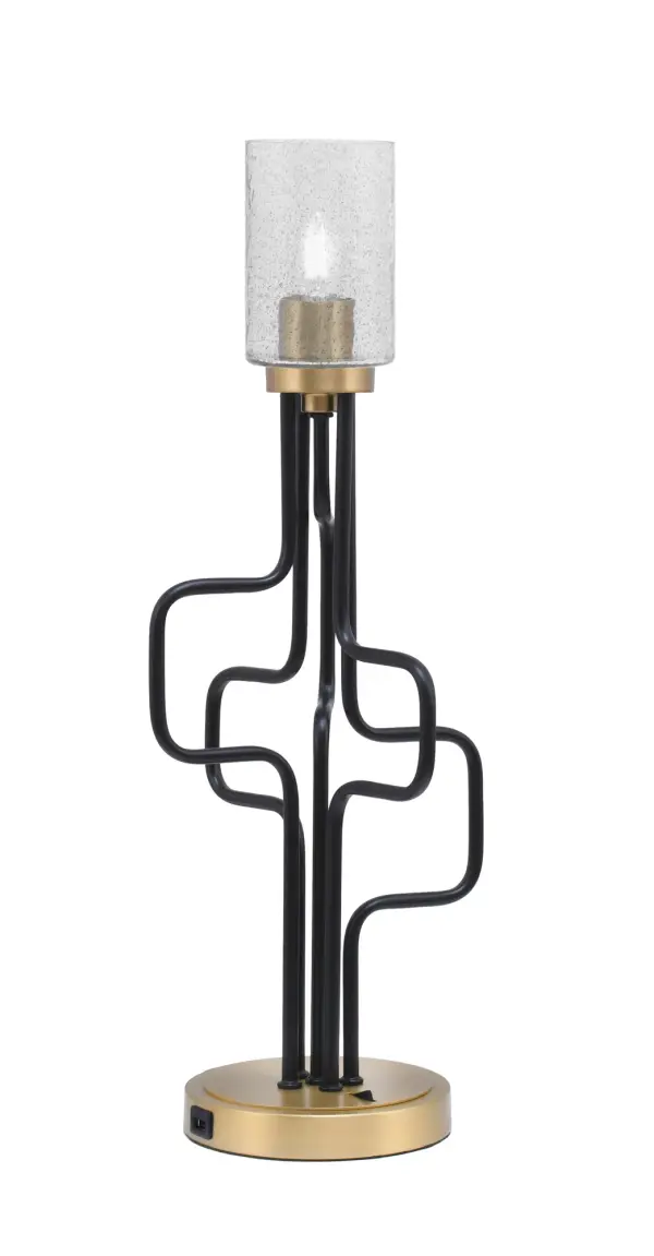 The Sandia Accent Lamp combines industrial aesthetics with modern functionality, featuring a striking matte black and aged brass finish paired with a unique smoke bubble glass shade. Built-in USB ports add practical convenience for charging devices.