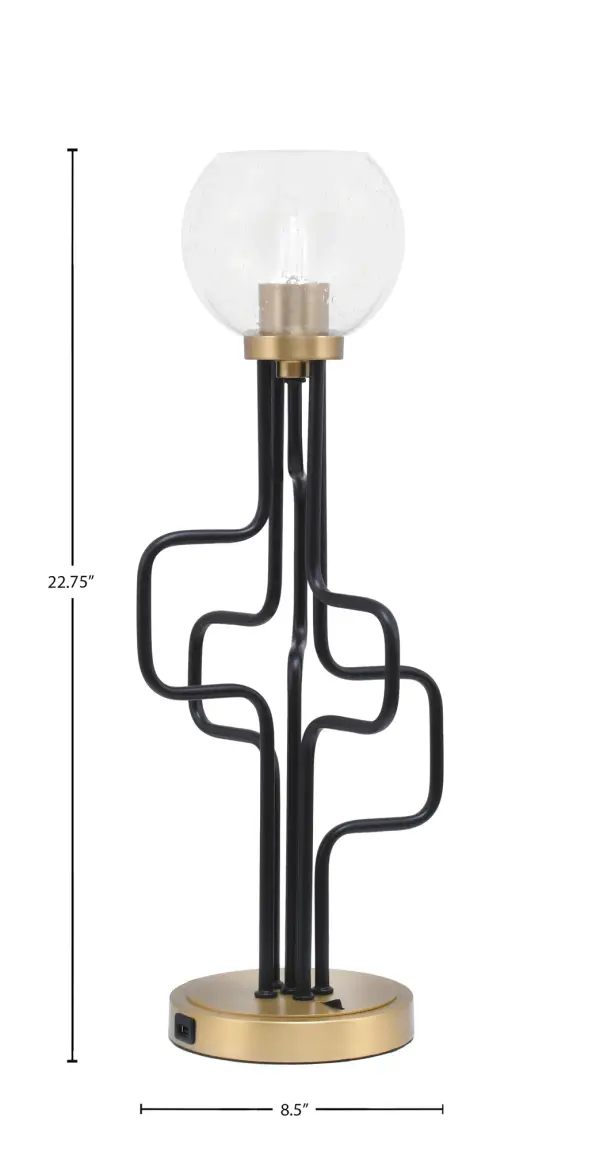 The Sandia Accent Lamp combines industrial style with modern functionality, featuring a striking matte black and aged brass finish with unique bubble glass shade. Built-in USB ports add practical convenience for charging devices. - alternate view