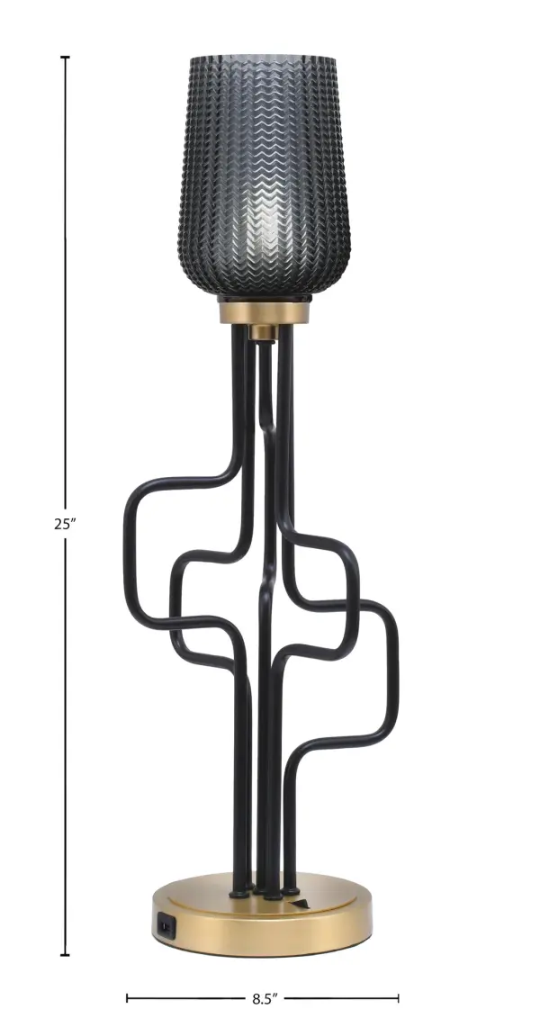 The Sandia Accent Lamp blends industrial style with modern convenience, featuring a striking matte black and aged brass finish. The 5" smoke textured glass shade creates ambient lighting while built-in USB ports add practical functionality. - alternate view