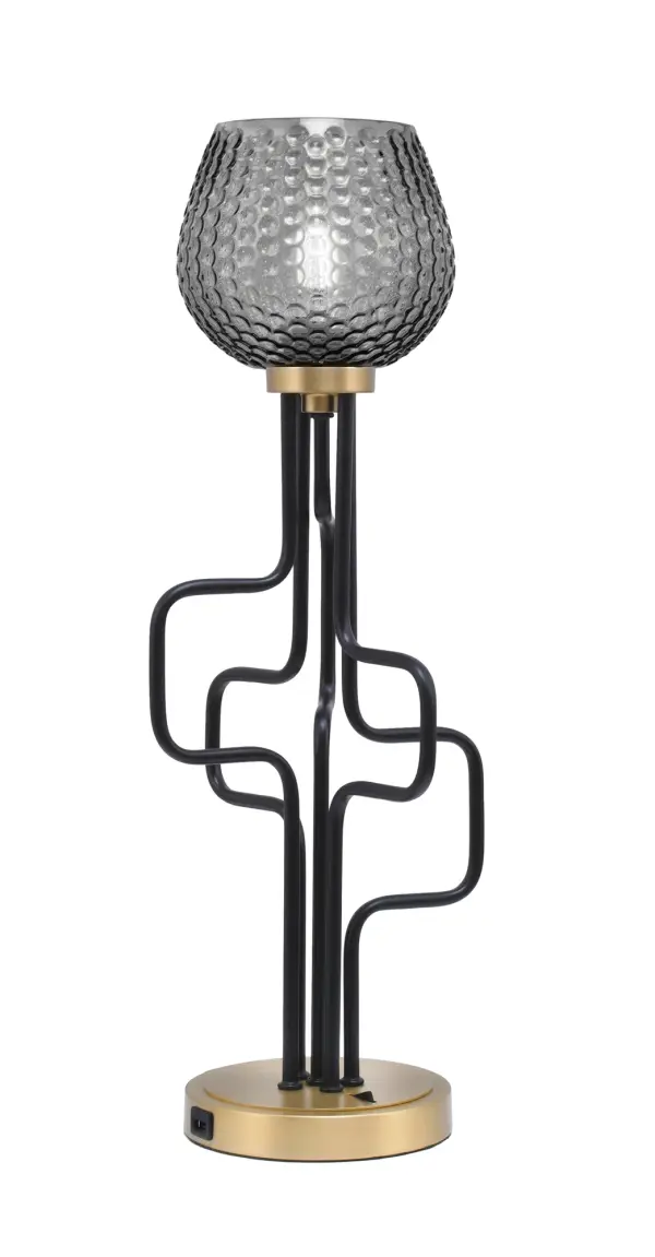 The Sandia Accent Lamp combines contemporary style with practical functionality. Its two-tone matte black and aged brass finish paired with smoke textured glass creates sophisticated ambiance while built-in USB ports add modern convenience.