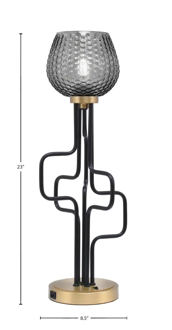 The Sandia Accent Lamp combines contemporary style with practical functionality. Its two-tone matte black and aged brass finish paired with smoke textured glass creates sophisticated ambiance while built-in USB ports add modern convenience. - alternate view