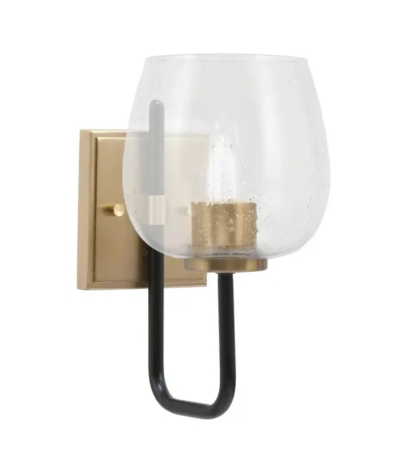 The Sandia Wall Sconce combines matte black and brass finishes with unique bubble glass for an eye-catching industrial-modern aesthetic. Compact at 6" wide, it's perfect for smaller spaces needing character and style.