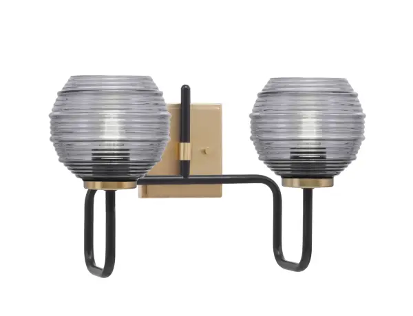 The Sandia 2-Light Bath Bar combines bold matte black with warm new age brass for a striking contemporary look. Smoke ribbed glass shades add texture while creating a soft, inviting glow perfect for bathroom vanities.