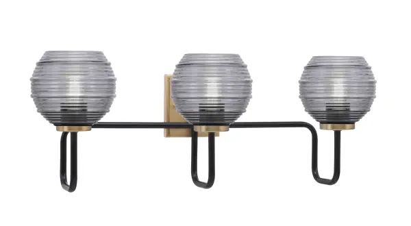 The Sandia 3 Light Bath Bar combines sophisticated matte black and brass finishes with smoke ribbed glass shades for a contemporary look. At 26.75" wide, it provides ample lighting for medium to large vanities while adding visual interest.