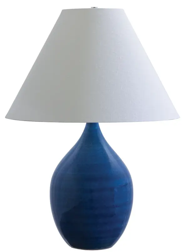 The Scatchard table lamp showcases artisanal American craftsmanship with its handmade stoneware base in a distinctive eggplant finish. At 28" tall, it provides substantial presence while maintaining versatility across traditional and contemporary interiors.