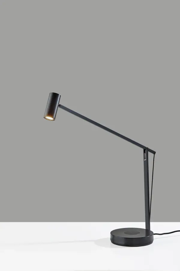 The Crane combines adjustable task lighting with contemporary convenience. Its flexible arm adjusts to any angle with spring-balanced precision, while integrated wireless charging and USB port keep devices powered. Energy-efficient LED and 4-way dimming make it ideal for focused work.