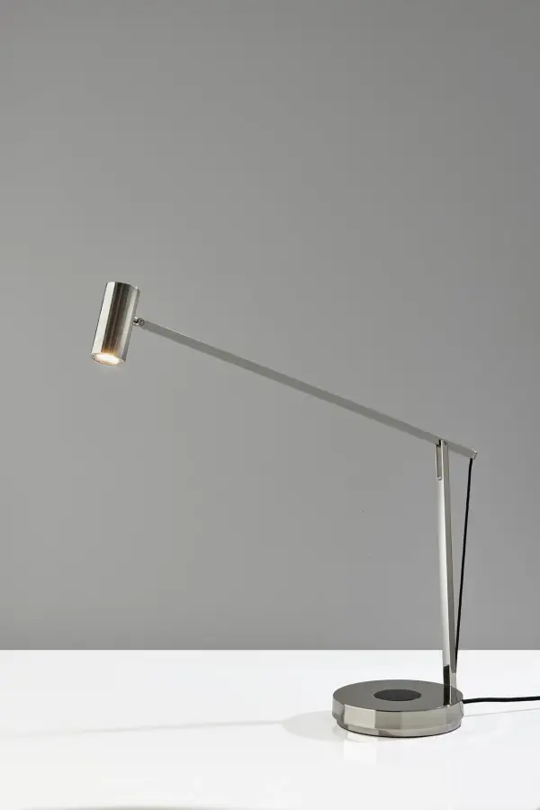 The Crane combines sleek contemporary design with practical functionality. Its flexible arm adjusts to any angle with spring-balanced precision, while integrated wireless charging and USB port keep devices powered. Energy-efficient LED and 4-way dimming make it perfect for focused work or ambient lighting.