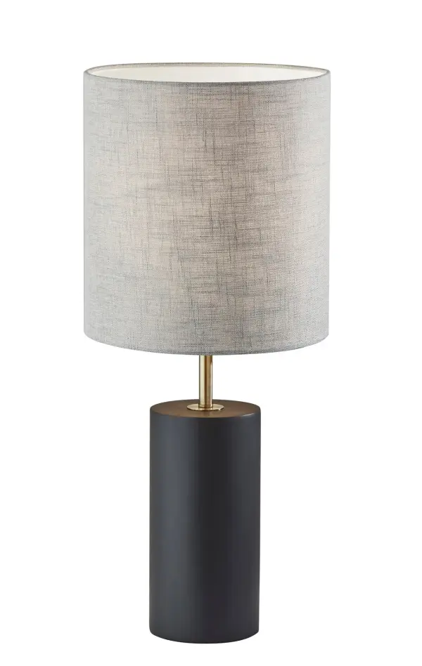 The Dean Table Lamp combines natural black poplar wood with antique brass accents and a textured grey fabric shade for a sophisticated modern look. At 30.5 inches tall with a compact 13-inch footprint, it delivers substantial presence without overwhelming smaller spaces.