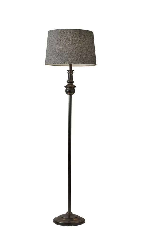 The Charles Floor Lamp combines timeless design with practical functionality. Its turned metal pole and base in black finish pair beautifully with a sophisticated herringbone fabric shade, creating versatile ambient lighting for any room.