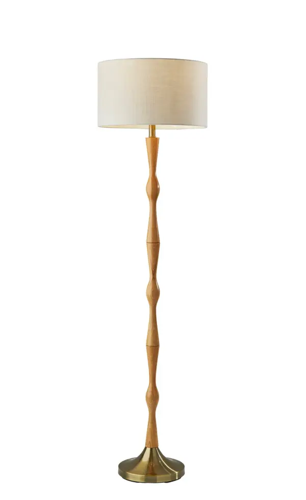 The Eve Floor Lamp brings warmth and organic style to any space with its natural oak wood body and antique brass base. The off-white textured fabric drum shade complements the soft-toned materials perfectly, creating a versatile lighting solution.