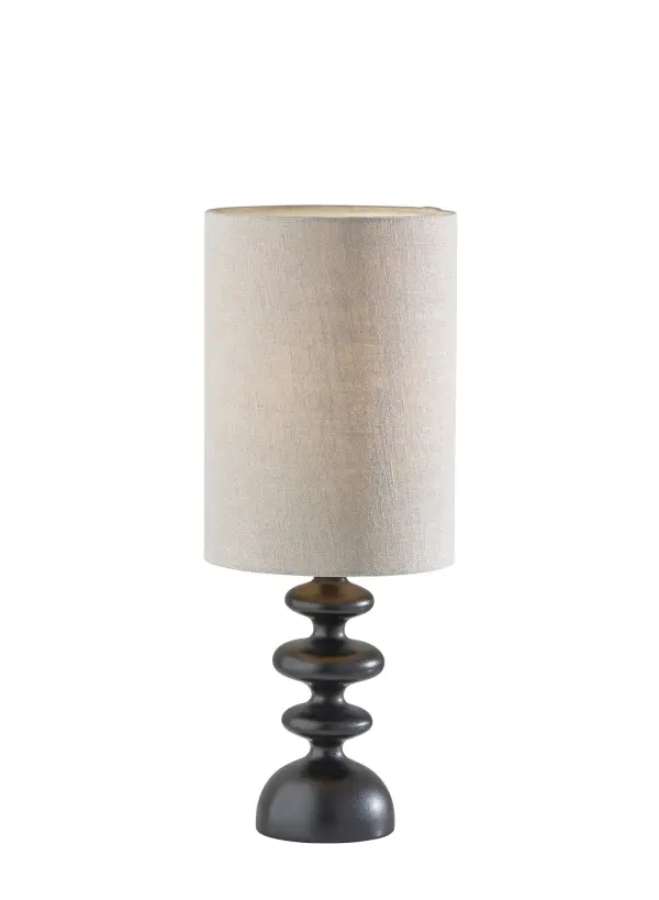 The Beatrice table lamp combines modern sophistication with functional design. Its distinctive sculptural stem features three round elements that create visual interest, while the taupe fabric shade softens the light beautifully.