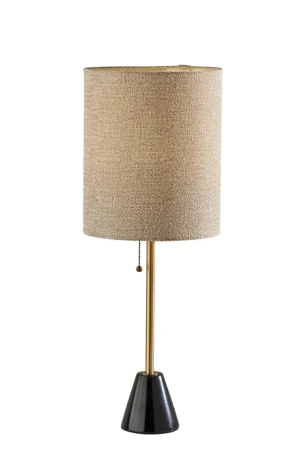 The Tucker table lamp combines luxurious black marble with warm antique brass and a beige woven shade for a refined, transitional aesthetic. At 28" tall, it's perfectly proportioned for nightstands and desks.