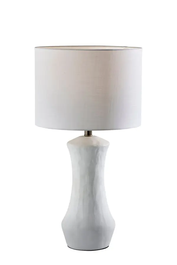 The Marissa Table Lamp combines classic elegance with modern simplicity through its matte white ceramic base and crisp white fabric shade. At 26 inches tall, it's perfectly sized for bedside tables and living spaces.