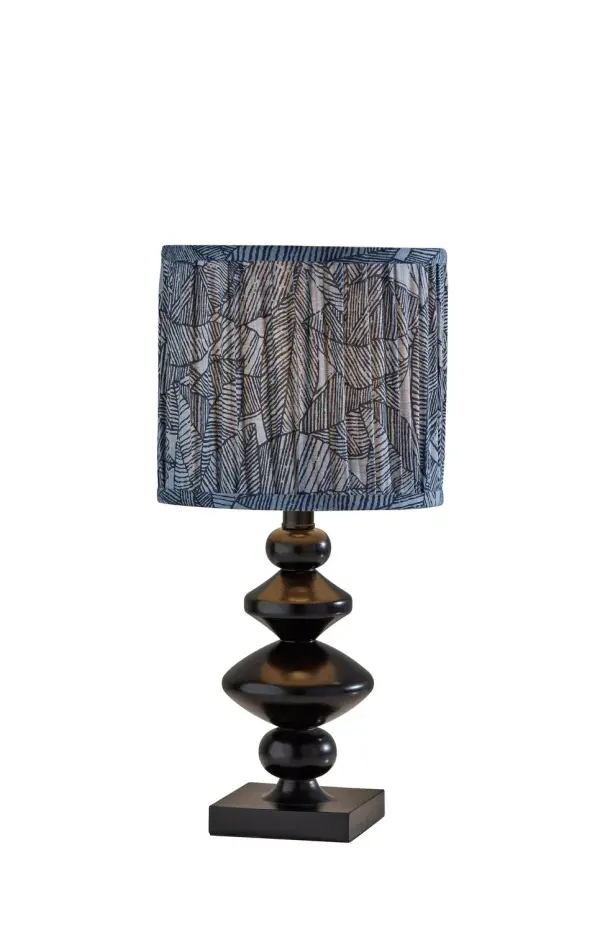 This compact accent lamp features a minimalist tapered shade and a sleek stem for a crisp modern silhouette. The streamlined design makes it ideal for layering light on a nightstand, desk, or shelf without taking up much space. Its rechargeable cordless format adds flexibility for everyday use. Collection: Samira Finish: Black Glass: Soft Pleated Blue Printed Fabric Width: 9.00" Height: 18.75" Length: 9.00" Weight: 5.72 lb Extension from Wall: 9.00" Wire: 60" Black Maximum Wattage: 60.00 W Bulb Base: E26 Material: Polyresin:50%, Metal:10%, Fabric:30%, Electrical parts:10% Country of Origin: Cambodia Safety Listing: ETL Switch: Rotary Socket Switch