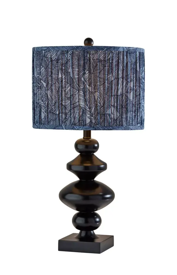 This compact accent lamp features a minimalist tapered shade and a sleek stem for a crisp modern silhouette. The streamlined design makes it ideal for layering light on a nightstand, desk, or shelf without taking up much space. Its rechargeable cordless format adds flexibility for everyday use. Collection: Samira Finish: Black Glass: Soft Pleated Blue Printed Fabric Width: 14.00" Height: 27.00" Length: 14.00" Weight: 8.59 lb Extension from Wall: 14.00" Wire: 60" Black Maximum Wattage: 100.00 W Bulb Base: E26 Material: Polyresin:50%, Metal:10%, Fabric:30%, Electrical parts:10% Country of Origin: Cambodia Safety Listing: ETL Switch: Rotary Socket Switch