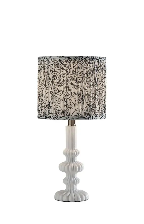 This cordless accent lamp pairs a shallow metal shade with a softly shaped wood-look base for a warm, modern feel. The mixed-material design brings together natural texture and clean lines, making it a versatile choice for side tables, bookshelves, and bedrooms. Its portable design lets you bring light where you need it most. Collection: Ambrose Finish: White Glass: Soft Pleated Navy/White Printed Fabric Width: 9.00" Height: 18.75" Length: 9.00" Weight: 6.05 lb Extension from Wall: 9.00" Wire: 60" Clear Maximum Wattage: 60.00 W Bulb Base: E26 Material: Polyresin50%, Metal:10%, Fabric:30%, Electrical parts:10% Country of Origin: Cambodia Safety Listing: ETL Switch: Rotary Socket Switch