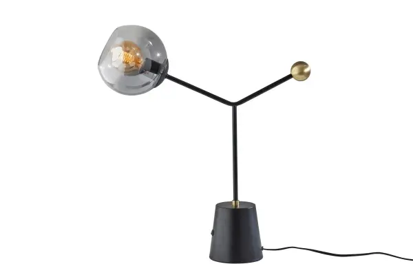 The Dusk Table Lamp combines contemporary design with functional elegance. Its chunky tapered metal base in black finish supports a captivating fading smoked glass globe shade that creates an alluring lighting effect. Perfect for modern bedrooms and living spaces.