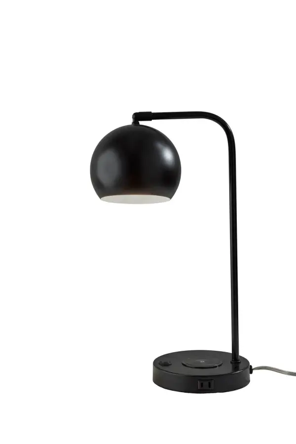 This compact table lamp features a rounded metal dome shade and a clean arched arm for a sleek modern look. Its integrated wireless charging pad and built-in outlet make it especially useful on desks, nightstands, and small tables. The streamlined shape keeps your space feeling uncluttered while delivering focused light. Collection: Emery Finish: Black Glass: Metal Width: 6.50" Height: 19.00" Length: 10.00" Weight: 5.17 lb Extension from Wall: 10.00" Wire: 72" Black Maximum Wattage: 60.00 W Bulb Base: E26 Light Source: Incandescant Material: Plastic -5% Metal - 60% Electric Parts - 20% Packing - 15% Country of Origin: Vietnam Safety Listing: UL Switch: Rocker Switch on Base