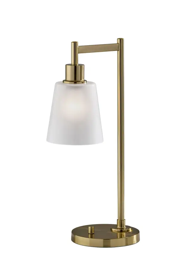 The Gio Desk Lamp combines bold geometric design with warm antique brass finish to create a sophisticated workspace accent. Its dual-textured white glass shade delivers beautifully diffused light perfect for reading and tasks.