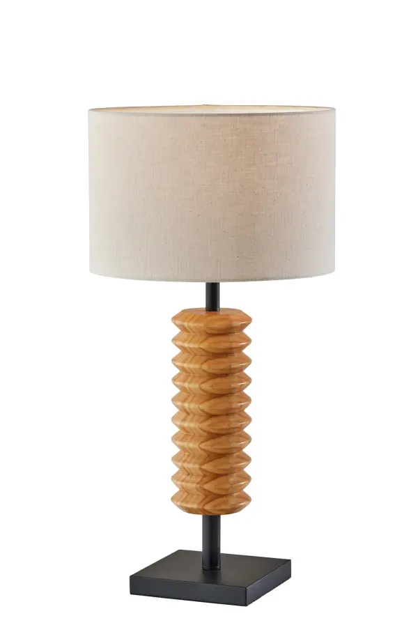 The Judith table lamp combines clean-lined black metal construction with a striking natural wood accent piece, creating a sophisticated contemporary statement. The textured cream drum shade softly diffuses light while the 3-way switch offers flexible brightness control.