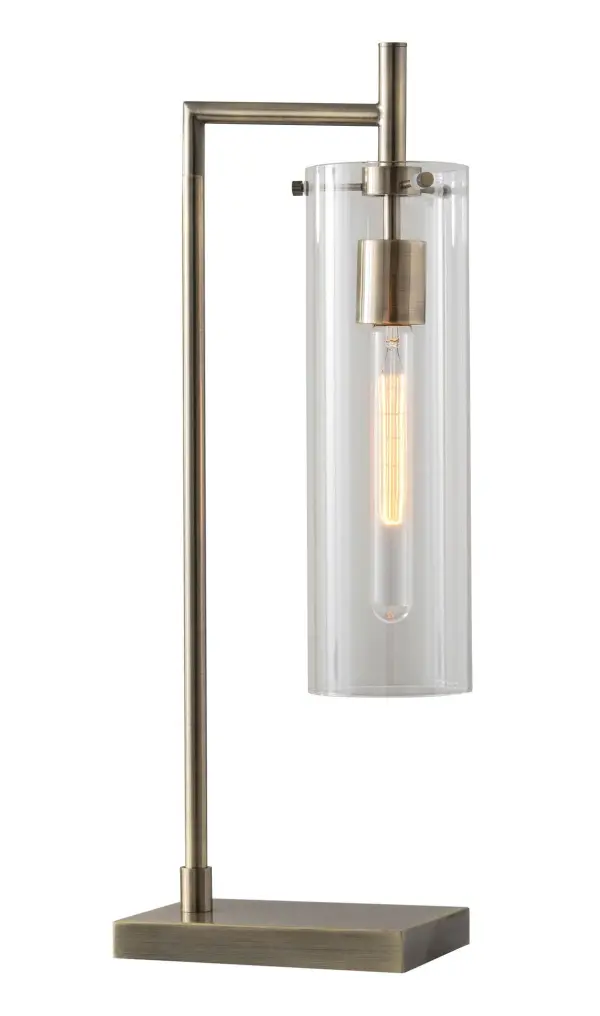The Dalton Desk Lamp combines industrial aesthetics with functional task lighting. Its clear glass cylinder shade showcases a vintage Edison tube bulb, while the antique brass finish adds warmth and sophistication to any workspace or bedside table.