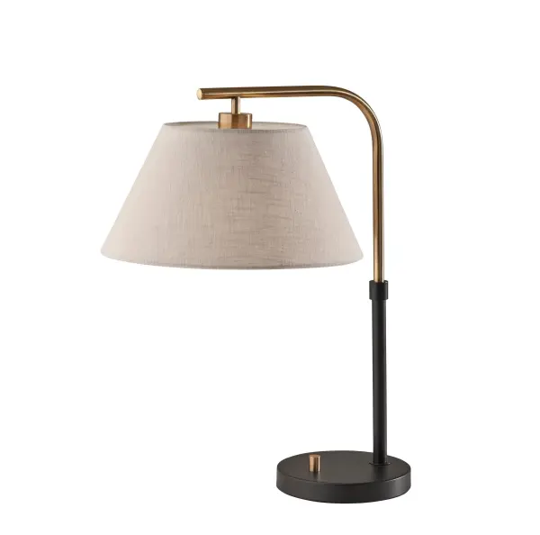 The Fletcher Table Lamp combines black and antique brass finishes in a striking mid-century modern design. At 21.25 inches tall with a textured fabric shade, it delivers both style and soft ambient lighting for any space.
