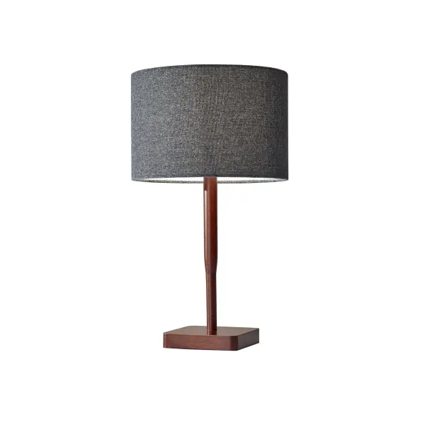 The Ellis Table Lamp combines natural walnut wood with a sophisticated dark grey textured fabric shade. Its simple silhouette and quality materials create an elegant design that complements any décor style.