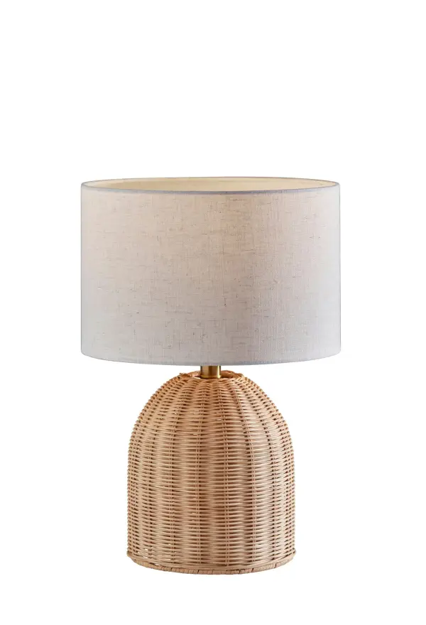 The Bali Table Lamp brings organic warmth through its handcrafted light rattan base and textured off-white drum shade. At 18.25" tall, it's perfectly sized for bedside tables or accent surfaces, offering coastal cottage charm or a natural counterpoint to modern interiors.