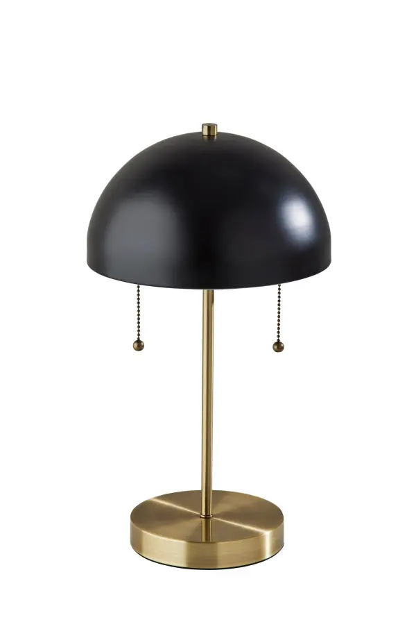 The Bowie table lamp combines mid-century modern aesthetics with practical functionality. Its geometric dome shade and dual-finish design create a striking statement piece, while the integrated AC outlet adds modern convenience.