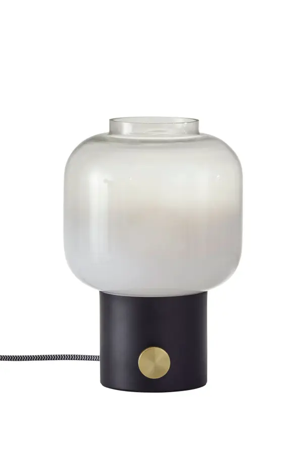 The Lewis Table Lamp combines contemporary style with practical functionality. Its distinctive white-to-clear gradient glass shade creates ambient lighting, while the matte black finish with brass accents adds sophistication to any space.