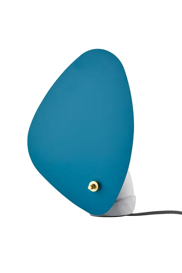 The Bonnie Table Lantern combines unexpected materials—turquoise metal and natural concrete—for a striking contemporary accent. Its irregular shade shape and wall-facing design create ambient lighting perfect for modern spaces.