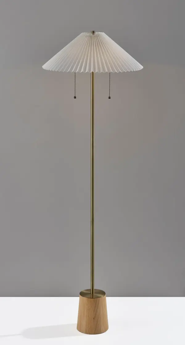 The Ophelia Floor Lamp masterfully combines a chunky natural wood base with a slim antique brass pole and white pleated shade. At 60 inches tall, it delivers warm, inviting light perfect for reading corners or ambient lighting.