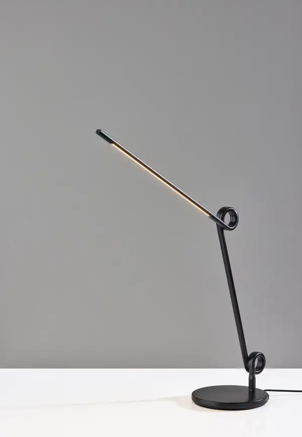 The Knot LED Desk Lamp combines sculptural design with practical functionality. Its articulating arm with decorative knot details allows precise light positioning, while integrated USB and USB-C ports keep devices charged. The 4-way touch dimmer and warm 3000K LED provide customizable task lighting in a sleek monochrome design. - alternate view