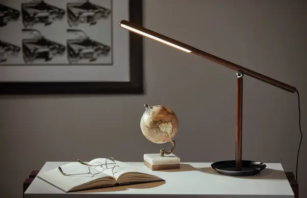 The Gravity LED Desk Lamp combines modern elegance with exceptional functionality. Its innovative magnetic ball joint allows endless adjustability, while the walnut ash wood and black metal design adds sophistication to any workspace. - alternate view