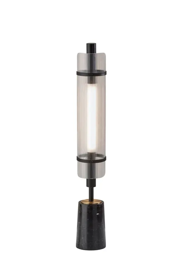 The Flair LED table lamp combines sophisticated materials with modern design, featuring a black marble cylindrical base, antique brass accents, and an integrated 8W LED with ribbed acrylic diffuser. Touch control offers four lighting levels.