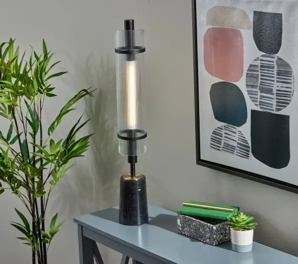 The Flair LED table lamp combines sophisticated materials with modern design, featuring a black marble cylindrical base, antique brass accents, and an integrated 8W LED with ribbed acrylic diffuser. Touch control offers four lighting levels. - alternate view