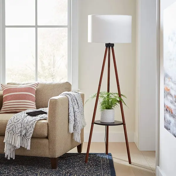 This versatile floor lamp combines timeless tripod styling with practical storage. The warm walnut finish and white linen shade create a clean, natural aesthetic that complements casual to contemporary spaces. - alternate view