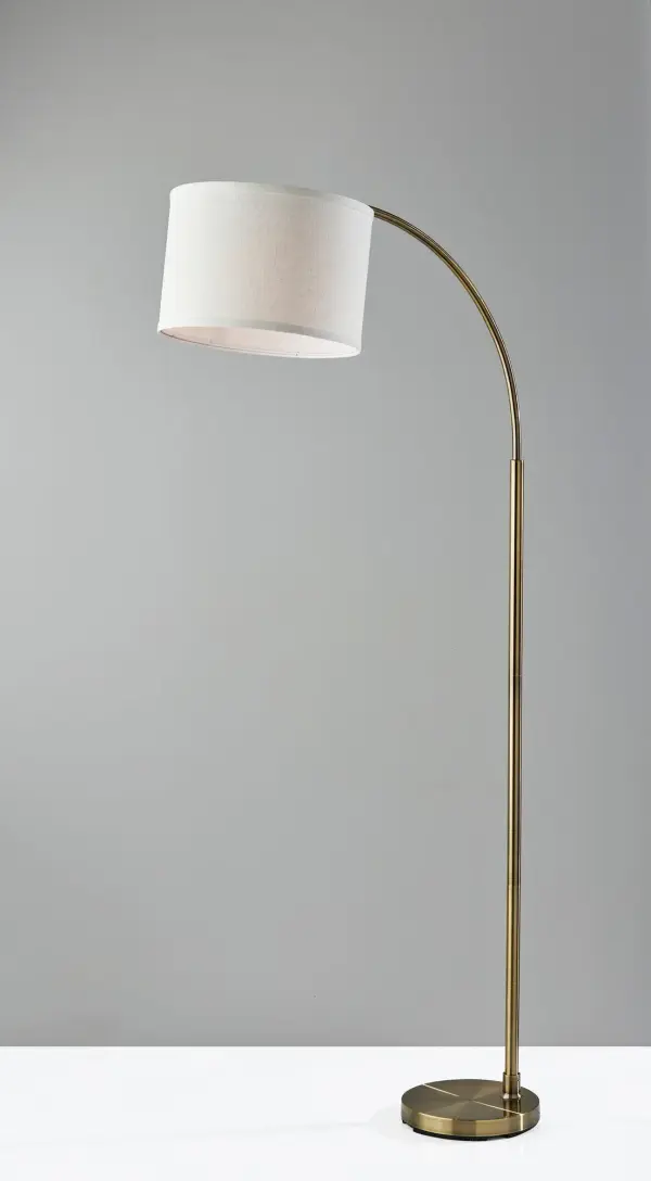 The 64-inch Jace floor lamp combines mid-century modern aesthetics with practical functionality. Its arcing design and adjustable shade make it ideal for reading or working, while the antique brass finish adds warmth to any space. - alternate view