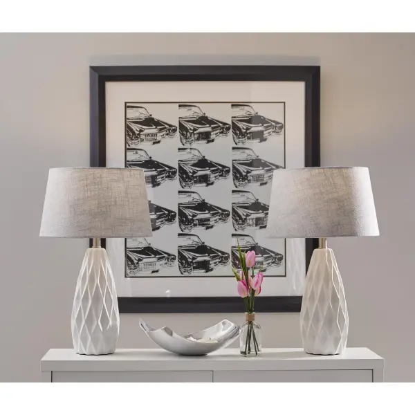 This bonus pack includes two matching table lamps featuring white geometric ceramic bases and light grey textured fabric shades. Perfect for creating symmetry in bedrooms or living spaces with contemporary style and functional lighting. - alternate view