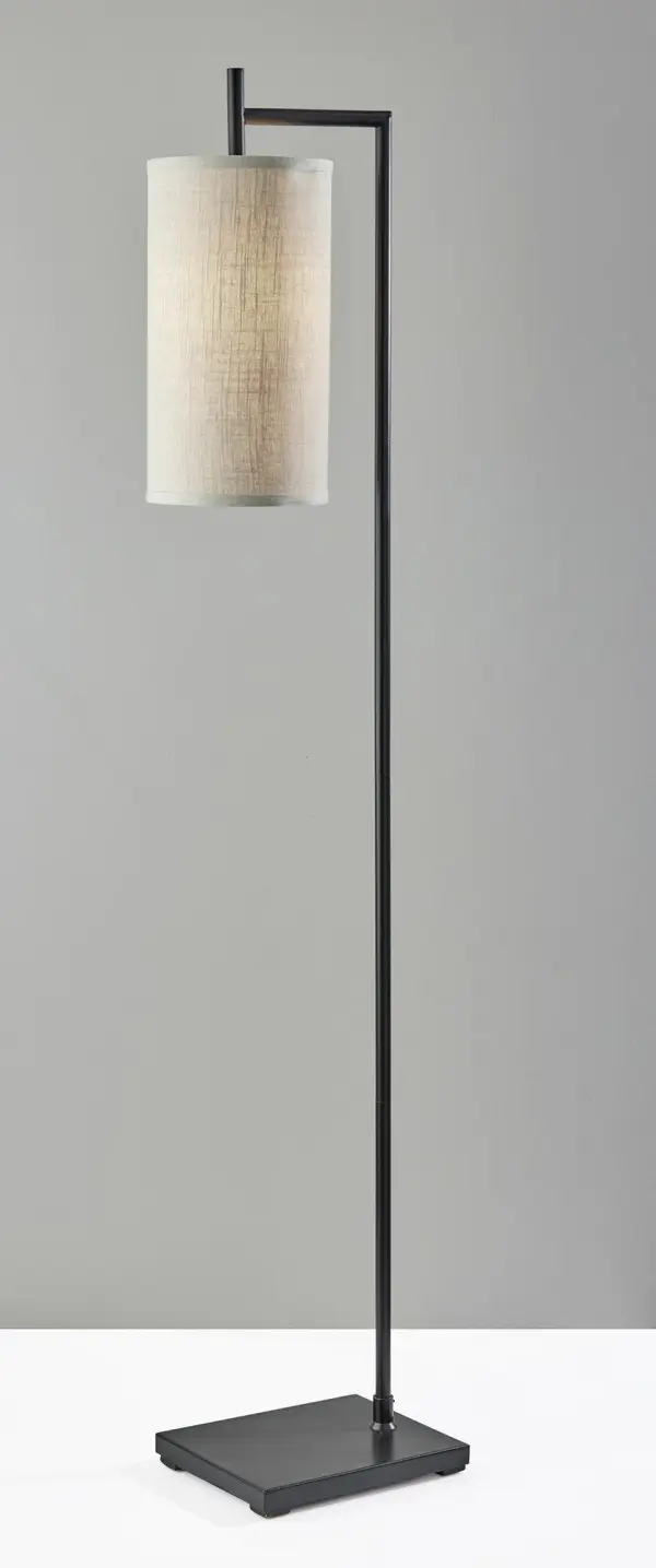 The Zion floor lamp combines clean architectural lines with a compact footprint, making it perfect for modern spaces. Its monochrome black finish and textured beige shade create sophisticated ambient lighting. - alternate view