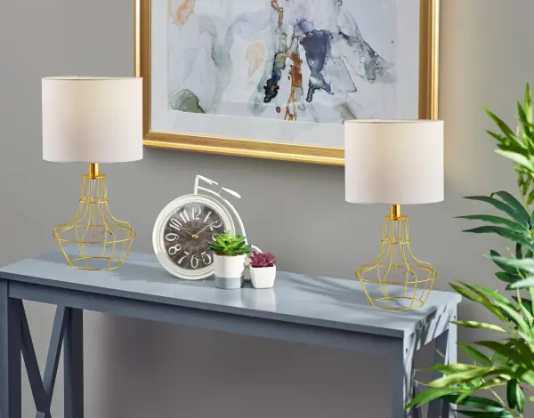 The Stella 2-piece bonus pack delivers modern industrial style with brass metal cage bases and white fabric shades. At 18.75" tall, these compact lamps are perfect for adding character to bedrooms, living spaces, or offices without overwhelming smaller surfaces. - alternate view