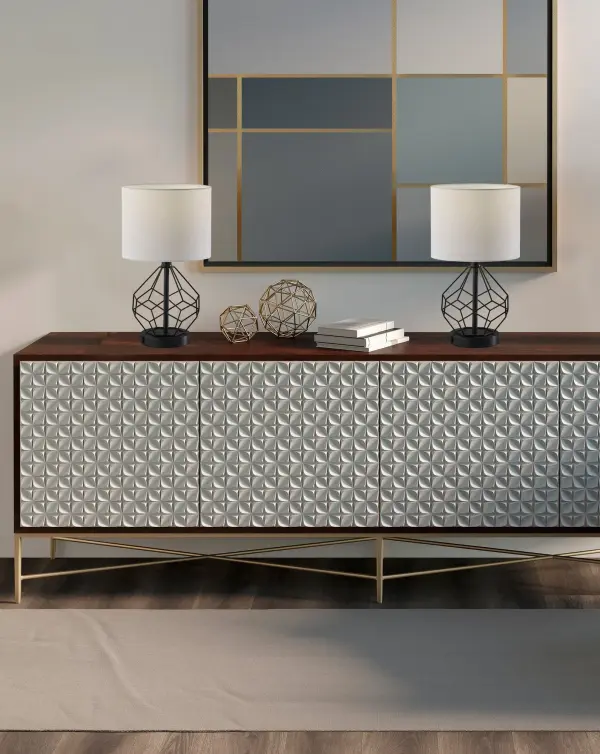 The Chiara 2-piece lamp set delivers contemporary industrial style with practical built-in AC outlets for device charging. Black metal cage bases paired with white fabric shades create striking contrast while the compact 16-inch height fits perfectly in smaller spaces. - alternate view