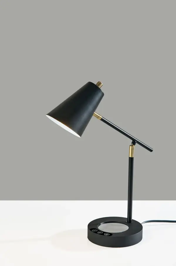 This innovative mid-century modern desk lamp combines task lighting with practical features including an integrated cup warmer, USB charging port, and AC outlet. The adjustable articulating arm and shade provide directional lighting control.