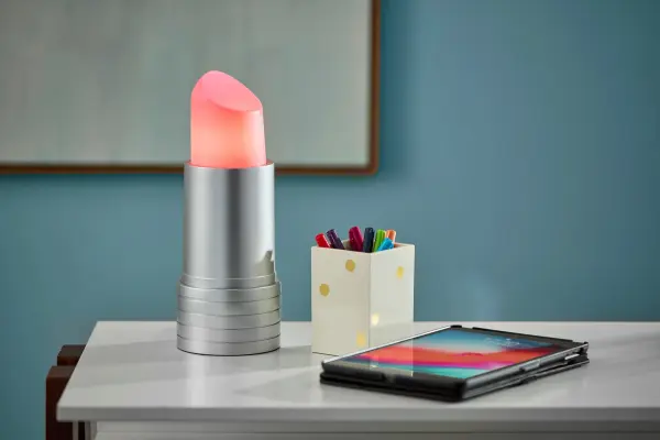 The Lipstick LED Lamp brings personality and fun to any space with its unique pink lipstick-shaped shade and sleek silver base. Compact yet impactful, this adjustable-height lamp is perfect for adding a pop of color to bedrooms, vanities, or makeup areas. - alternate view