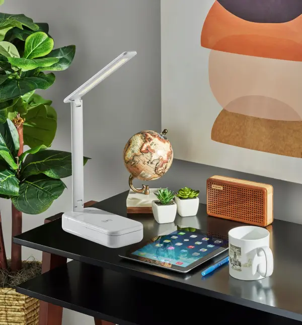 This innovative desk lamp combines three essential functions: adjustable LED task lighting with smart touch controls, laboratory-tested UV-C sanitization for everyday items, and convenient wireless charging for multiple devices. - alternate view