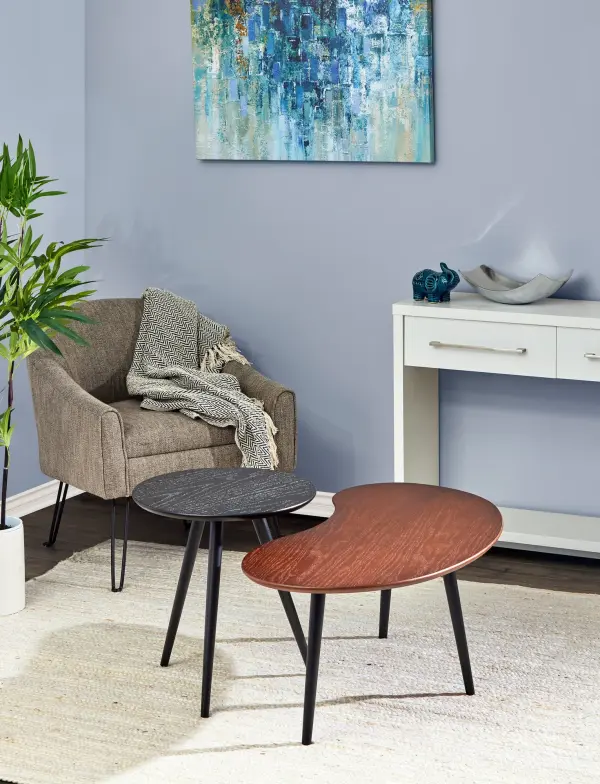 The Gilmour nesting tables offer versatile functionality with their unique bean and round shapes. Featuring complementary walnut and black oak veneers with tripod rubberwood legs, this set is perfect for smaller spaces. - alternate view