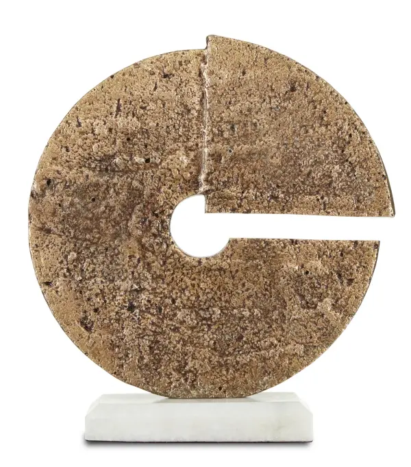 A striking decorative disc sculpture featuring heavily pitted cast aluminum with aged brass finish on a beveled white marble base. The intense surface texture and natural patina create visual depth and artisanal appeal.