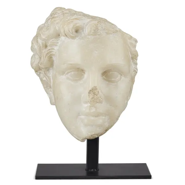 This striking reproduction of an ancient Greek princess head fragment brings classical elegance to any space. Expertly crafted from composite with convincing weathered details and an aged-beige finish that mimics carved stone.