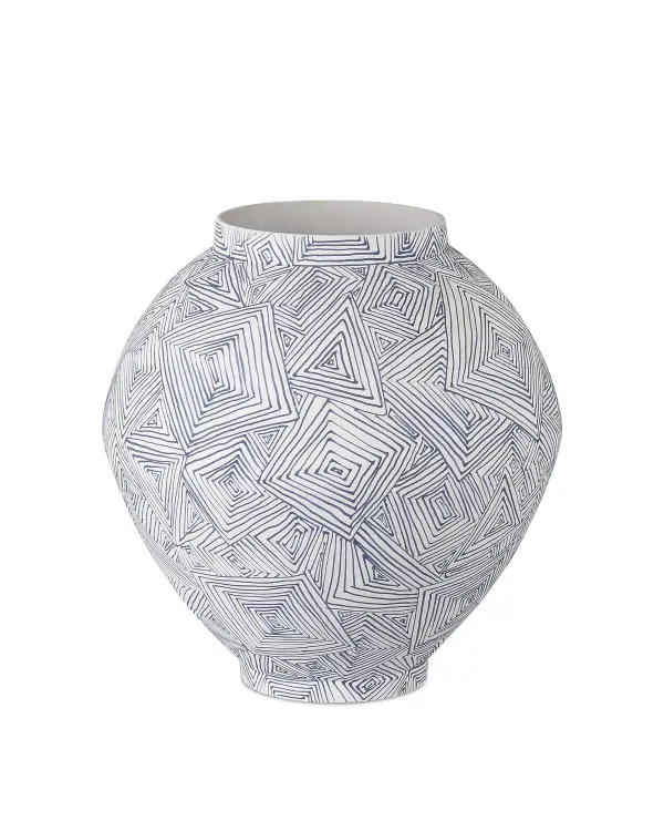 This artisanal medium vase showcases hand-thrown porcelain with a striking blue and white telescoping pattern inspired by Imperial Japanese art. Each piece is individually hand-glazed with raised geometric details.